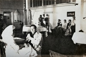 view The Royal Hospital, Haslar, England: the massage room: a nurse massages a patient's arm. Photograph, 1914/1918.