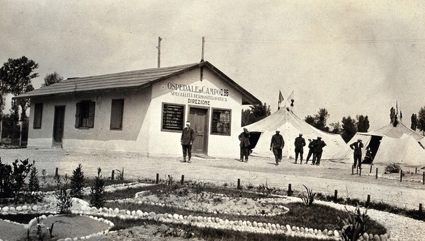 World War One: near Gradisca, Italy: a field hospital specialising in dermatology with soldiers outside. Photograph, 1917.