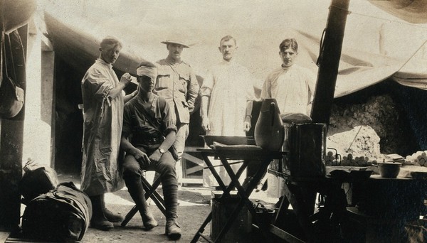 World War One: Fricourt, France: a makeshift dressing station in a shell hole: a soldier has his eye bandaged. Photograph, 1916.