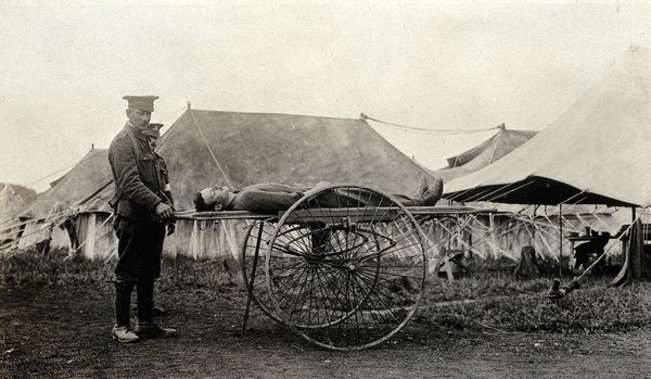 World War One: a stretcher with large wheels bearing a patient. Photograph, 1916.