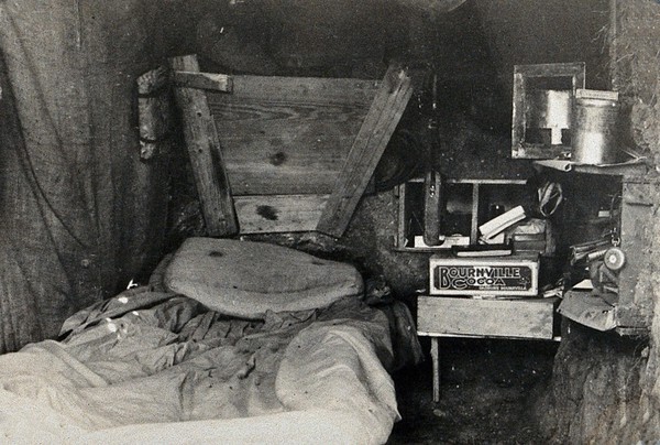 World War One: a dug-out interior showing bed. Photograph, 1914/1918.