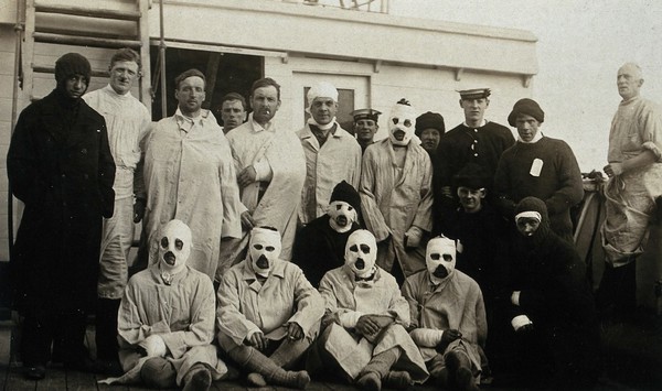 World War One: men wounded at the Battle of Jutland on board a hospital ship; several with bandaged faces. Photograph, 1916.