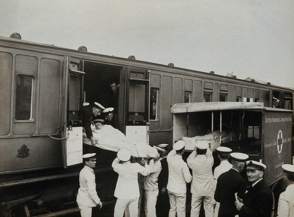 World War One: Chatham, England: loading stretchers onto a Red Cross train from an ambulance. Photograph, 1914/1918.