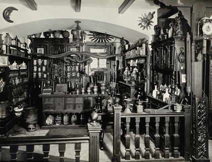 An apothecary's shop, Switzerland: reconstruction of a late 17th century shop, showing pharmacy equipment and decorations. Photograph, ca. 1920.