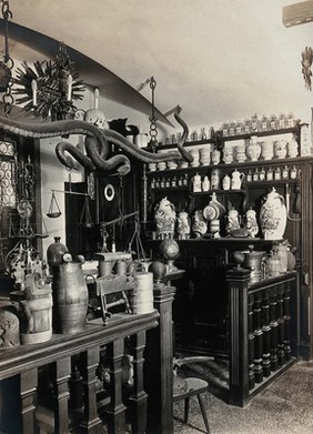 The pharmacy of C. Hersbrunnen (?), Lucerne, Switzerland: a reconstruction of the 18th century shop showing pharmacy equipment and decorations: side view. Photograph, ca. 1920.