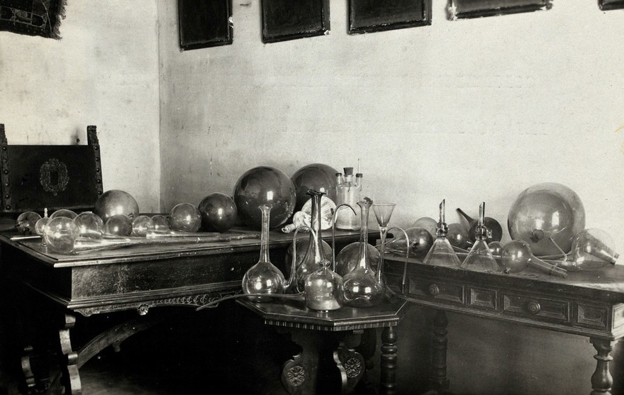 The Hospital of Arezzo, Italy: the Murano glass collection displayed on three tables. Photograph, 1920/1940.