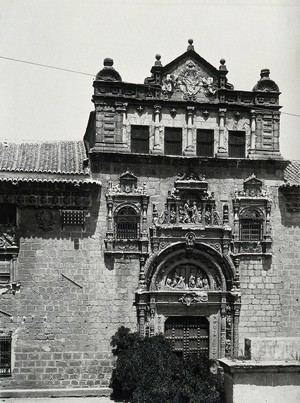 view Hospital de Santa Cruz, Toledo, Spain: the ornate 16th century facade, showing a doorway and windows. Photograph, ca. 1935.