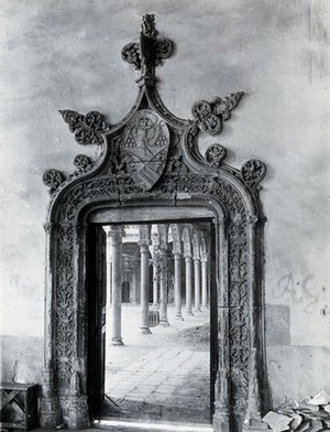 view Hospital de Santa Cruz, Toledo, Spain: the ornate doorway to the patio, showing columned arcade beyond. Photograph, ca. 1935.