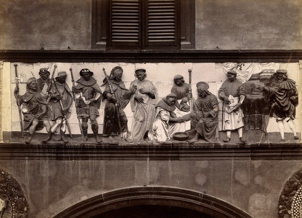 Ospedale del Ceppo, Pistoia: part of the sculpted relief of the works of mercy. Photograph by Alinari, 18--.