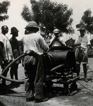 view Medical Research Institute, Accra: disinfection with a spray from a tank. Photograph, 1928.