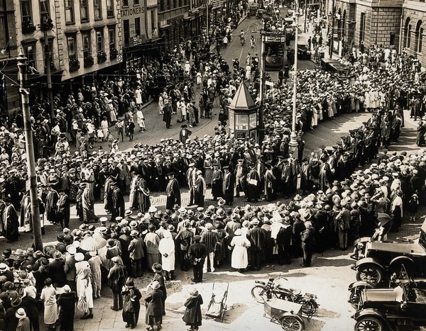 Bath: a procession of doctors watched by bystanders, at the annual meeting of the British Medical Association. Photograph, 1925.