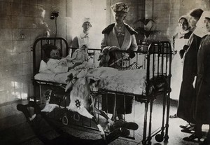 view Elizabeth Garrett Anderson Hospital, London: Queen Mary visiting a children's ward. Photograph, 192-.