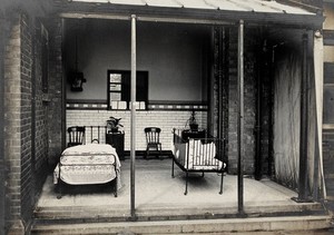 view Nottingham: a verandah open to the air with a bed and a cot, each containing a child being treated for acute illness. Photograph, 1893.