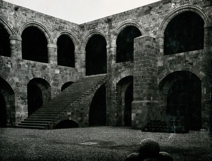 Hospital of the Knights of Saint John, Rhodes: courtyard with stairway leading to the top wards. Photograph, 1931.