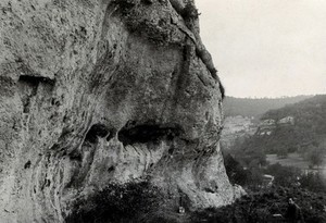 view Les Eyzies de Tayac, Dordogne, France: medieval water catchment and platform in rocks above the village, looking east. Photograph, ca. 1946.