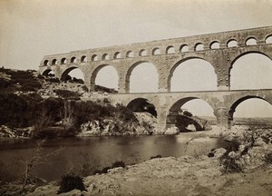 view Pont du Gard, Roman aqueduct, Nîmes, France: the River Gard is seen flowing beneath the aqueduct. Photograph, 1910/1936?.