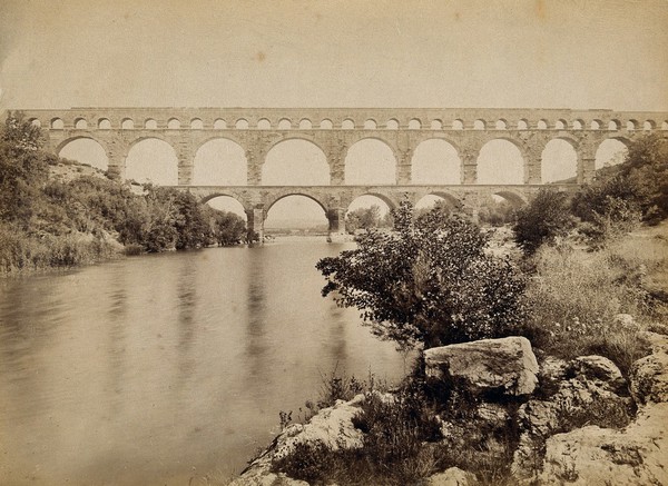 Pont du Gard, Roman aqueduct, Nîmes, France: the River Gard is seen in the foreground. Photograph by Neurdein Frères.