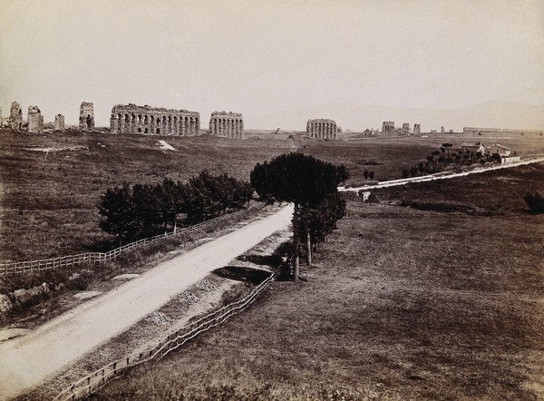 The Claudian aqueduct (Aqua Claudia), Rome, with the Via Appia in the foreground. Photograph, 1880/1920?.