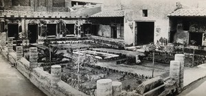 view Herculaneum: the peristyle of a Roman patrician's house, showing a small central foundain surrounded by a courtyard garden. Photograph, ca. 1931.