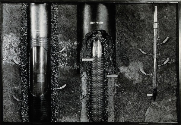 Demonstration model of equipment used for boring into the earth to extract water (?): the groundwater level is indicated with small labels. Photograph, ca. 1936.