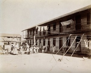 view Tenement building 'Poloni', San Rafael Street, Corner Oquedo, Cuba: an exterior view of the building on laundry day, with the inhabitants outside. Photograph, 1902.