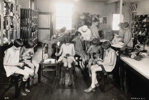 view Occupational therapy at the Mont Alto Sanatorium for tuberculosis, Pennsylvania: girls are shown darning socks in the laundry room. Photograph, 1920/1940?.