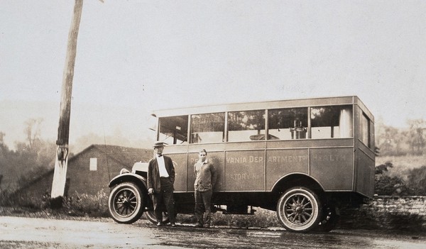 Pennsylvania state laboratory water car, owned by the Pennsylvania Department of Health: two men are shown standing in front of the motor vehicle. Photograph, 1910/1930?.