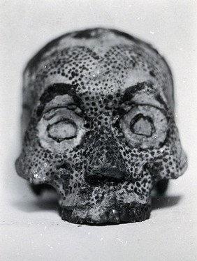 A human skull, decorated by the Konyak Nagas tribe, India: front view. Photograph by John Henry Hutton, ca. 1929 (?).