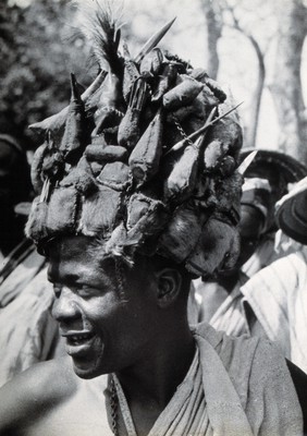 Africa: a man wearing a head-dress (made of animal skins?). Photograph (by Kurt Lubinski?), 1940/1960.