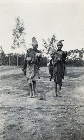 Uganda: two Ankole medicine men in ceremonial costume. Photograph by John Roscoe, 1919/1920.