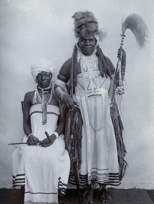 Africa: a man (a witchdoctor ?) and a woman in ceremonial dress. Photograph, 1920/1930.