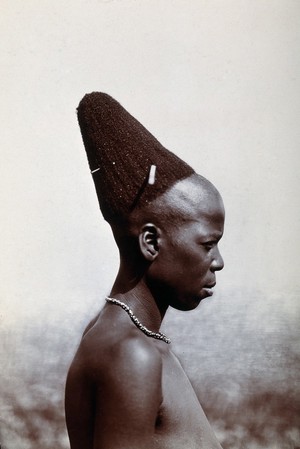 view Zululand: a married Zulu woman with a pyramidal hairdressing. Photograph.