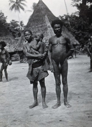 Papua New Guinea (?): a man with a woman and child. Photograph by E.W. Pearson Chinnery (?).