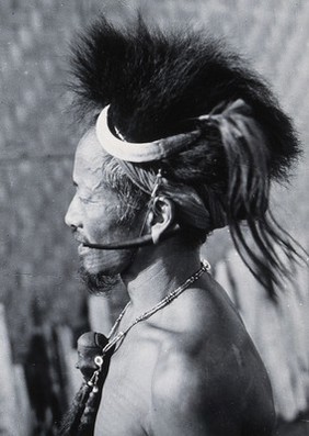 A man of the Konyak Naga tribe, with a necklace indicating that he has cut off a man's head. Photograph by Christoph von Fürer-Haimendorf, ca. 1937.
