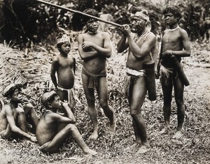 view Borneo: a Dyak man demonstrating the blowpipe. Photograph, 19--.