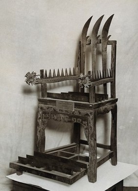 China: a chair equipped with blades for performances by mediums (tangki). Photograph, 19--.