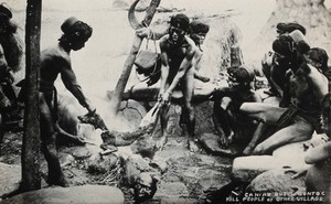 view Mountain Province, the Philippines: villagers of Caneo, Bontoc region, roasting a dog; a human head lies on the ground. Photograph, 19--.