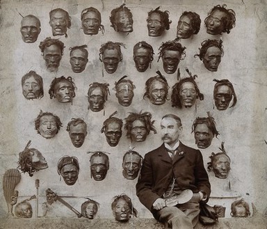Horatio Robley, seated with his collection of severed heads of Maori people. Photograph by H. Stevens, 190-.
