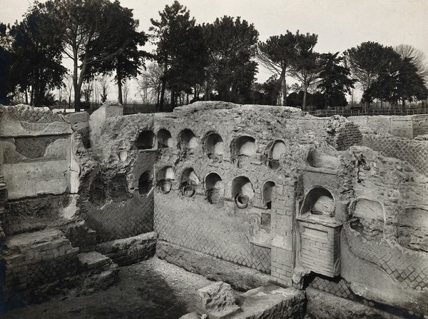 Ostia, Rome: columbaria for holding urns containing the ashes of the dead. Photograph by Fratelli Alinari, 192-.
