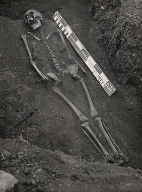 Caerwent, Wales: a grave showing a skeleton during excavation. Photograph, 1910.
