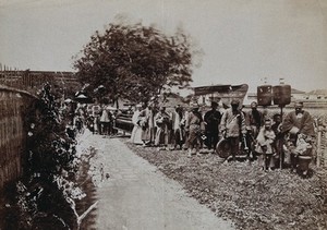 view Shanghai, China: a funeral procession, with people carrying banners. Photograph, 18--.