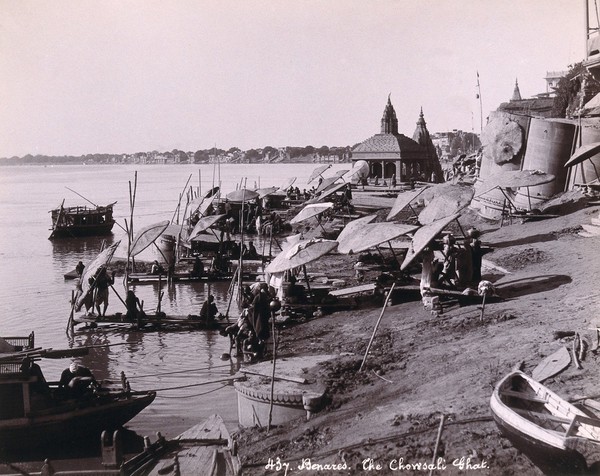 Benares (Varanasi), Uttar Pradesh: people bathing in the river Ganges. Photograph.