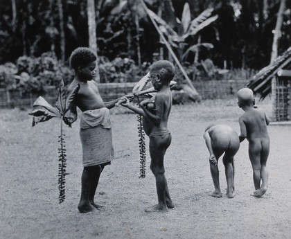 Africa: children playing games in a village. Photograph, ca. 1940 (?).