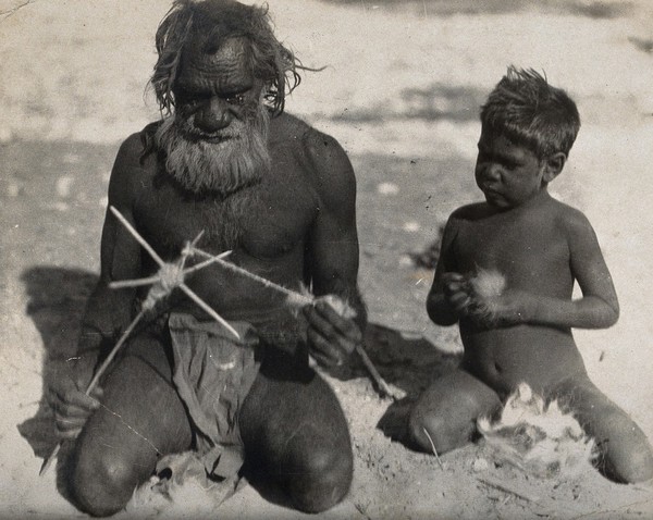 A man spinning string helped by a small boy. Photograph, 1900/1920 (?).