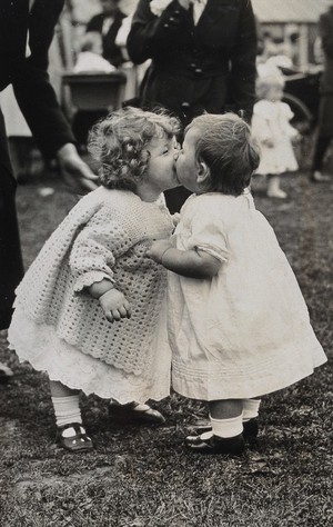 view Beckenham Baby Show, London: two toddlers kissing. Photograph, 1922.