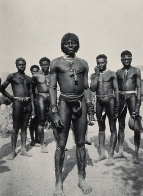 South Africa: Zulu men wearing penis sheaths and ornamental jewellery. Photograph, ca. 1910 (?).