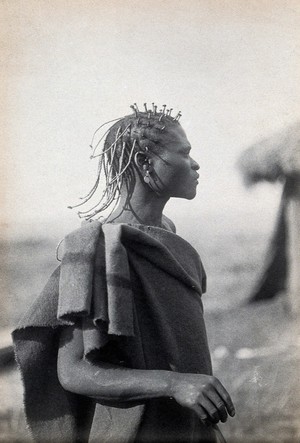 view South Africa: a Pondo man with an elaborate hairstyle. Photograph, ca. 1900.