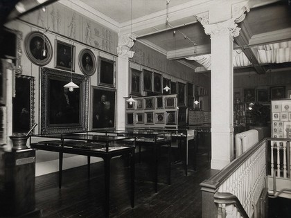 Wellcome Historical Medical Museum, Wigmore Street, London: west wall of the Gallery of Pictures. Photograph.