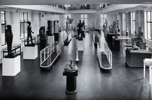 view The Wellcome Research Institution's building, Euston Road, London: the Hall of Statuary of the Wellcome Historical Medical Museum as arranged in the 1930s. Photograph.