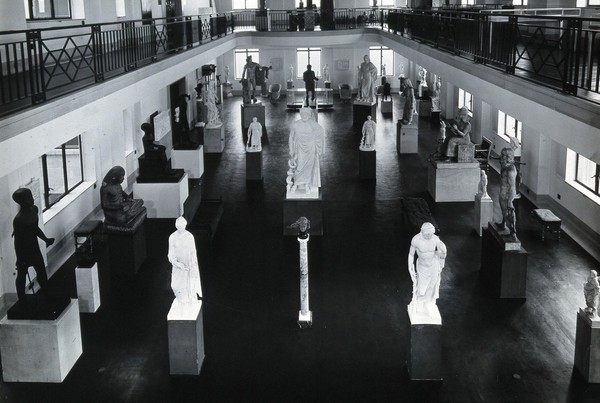 The Wellcome Research Institution building, Euston Road, London: the Hall of Statuary of the Wellcome Historical Medical Museum as arranged in the 1930s. Photograph.